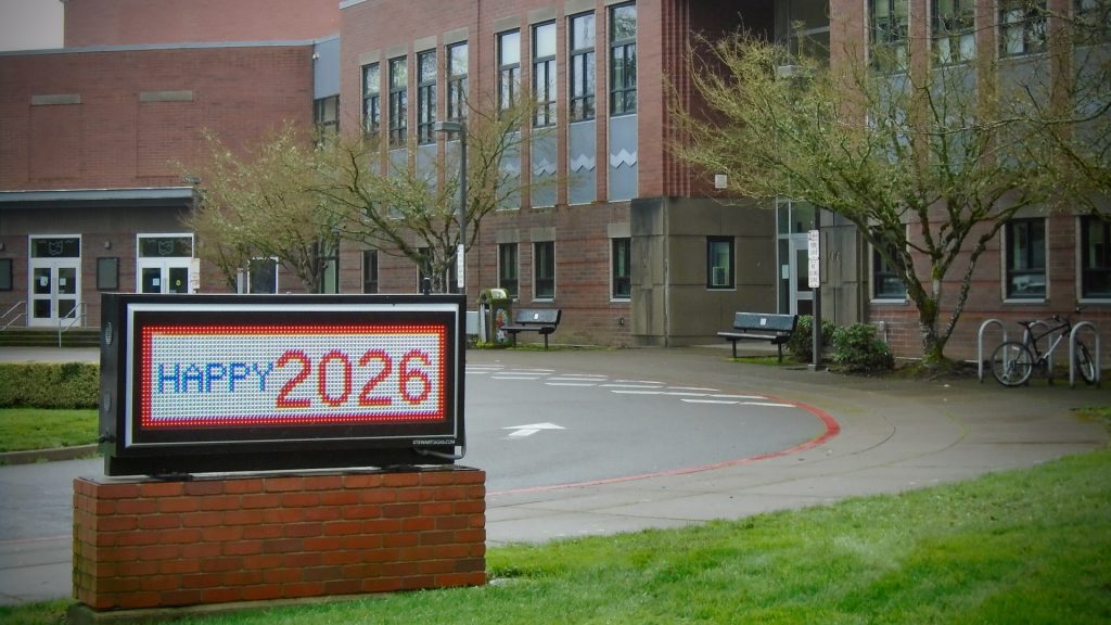 Electronic sign in front of the Corvallis High School with the message "Happy New Year."